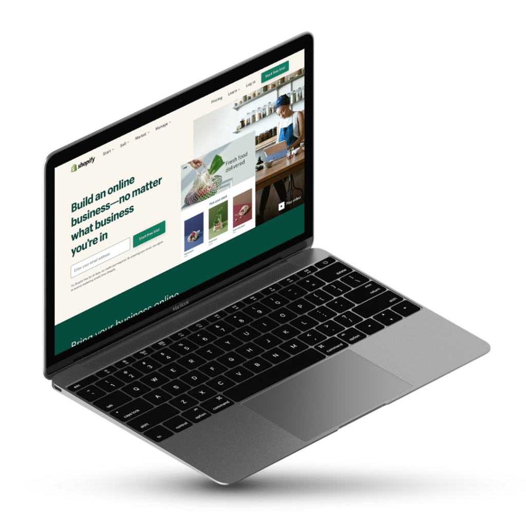 A laptop with the Shopify homepage on the screen